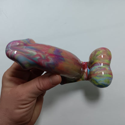 Hand holding the toy showing the view from the top down. The underside of the shaft and balls - they are connected by thin silicone that allows the balls to move.