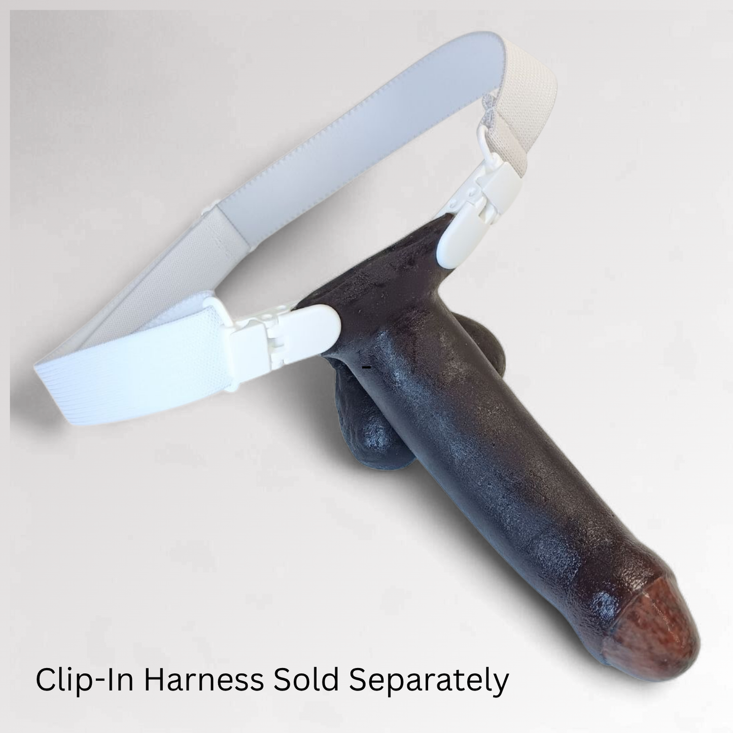 7 inch Action Toy in white Clip In Adjustable Waistband Harness.  Small text reads 'Clip-In Harness Sold Separately'