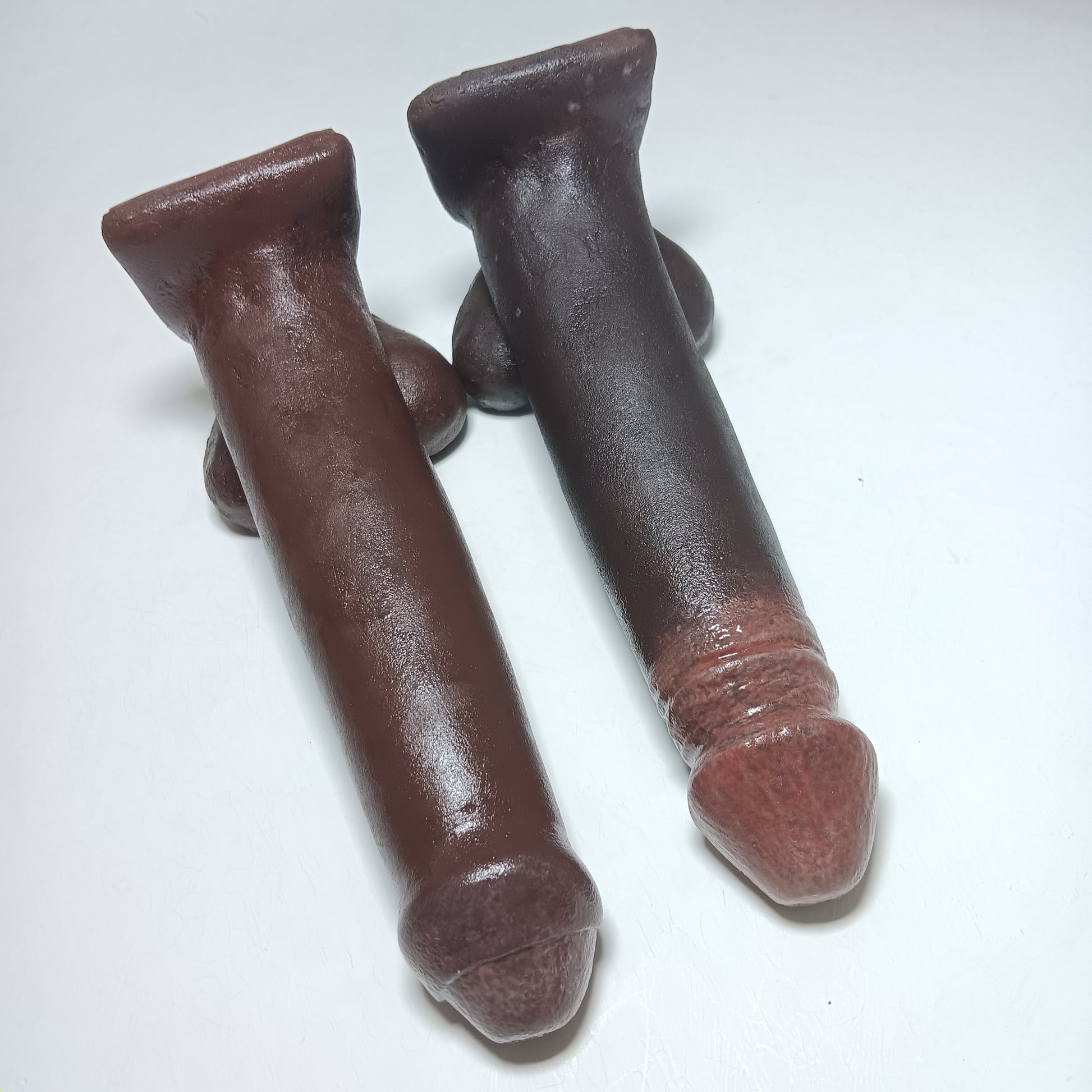 Showing the style choice difference of circumcised and uncircumcised realistic silicone prosthetic in the 7 inch Action Toy on a white background.
