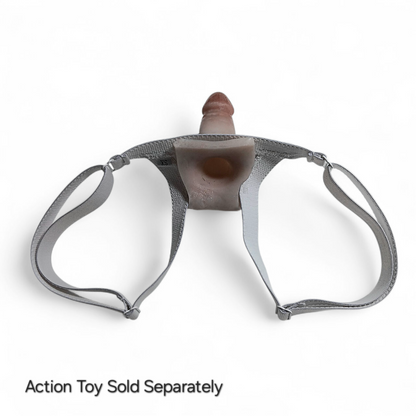 Showing the backside of the Slingshot harness with an Action toy holstered in it.  You can see the suction hole in the base of the Action toy for wearer suction.