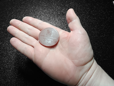 Image of color sample in hand, it's the size of a large coin