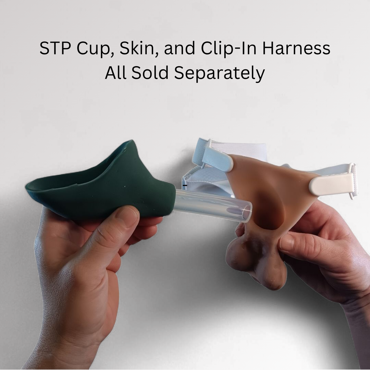Hands holding a green STP cup and a clip-in harness and STP Skin with text indicating separate sales.
