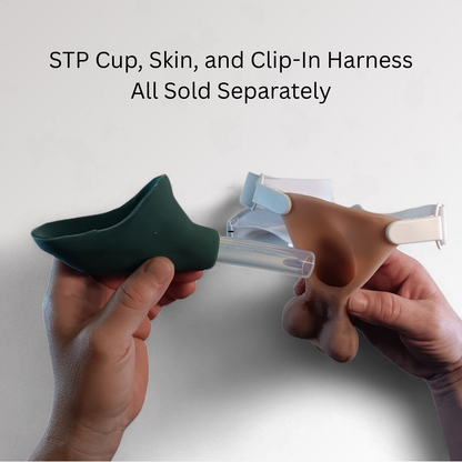 Hands holding a green STP cup and a clip-in harness and STP Skin with text indicating separate sales.