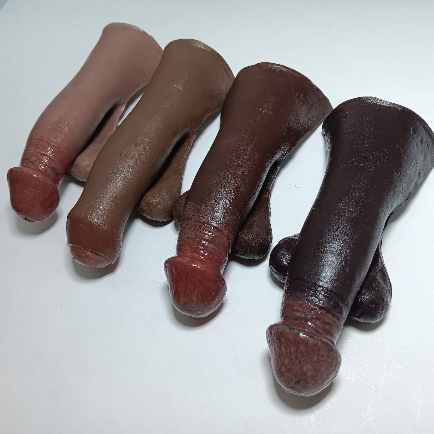 Four 5 inch STP Skins on a white background, showing the 4 deepest colors- colors 5, 6, 7, and 8.  Fully painted super realistic STP and FtM packer.