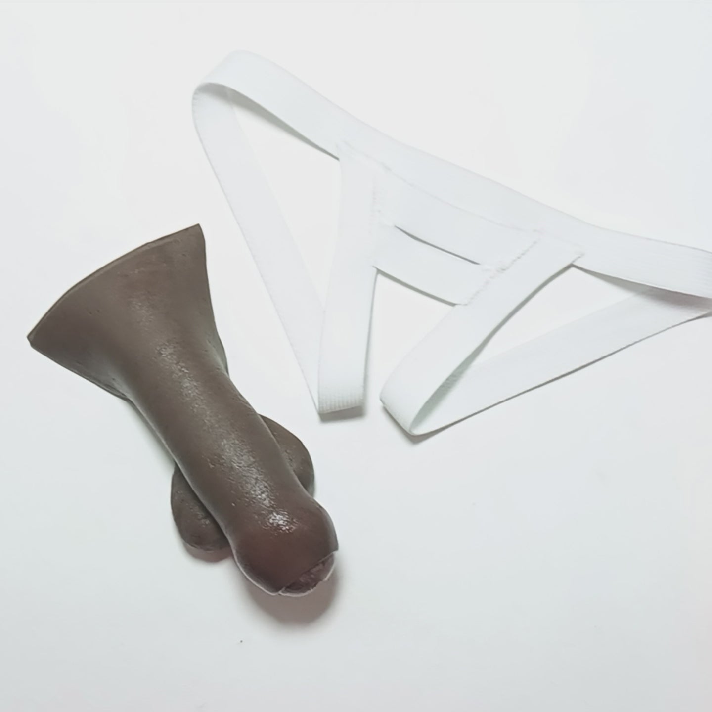 Demonstrating the 4 inch STP Skin in the Slingshot harness.  The shaft slides through a slit in the elastic front panel and hangs down from two leg straps on either side.